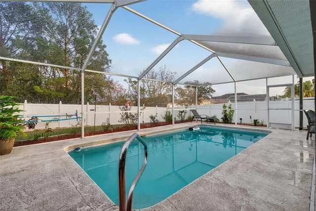a swimming pool with outdoor seating and yard