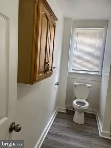 a bathroom with a toilet and a window