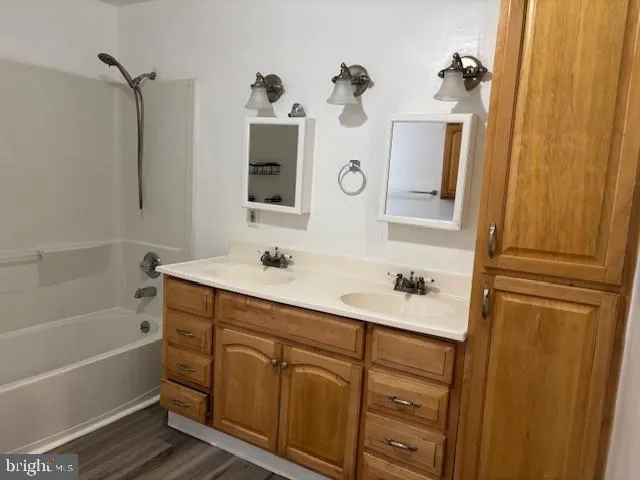 a bathroom with a sink vanity tub and shower