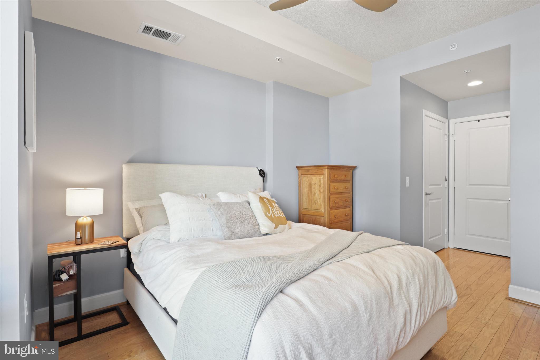 3600 South Glebe Road, Unit 414W Arlington, VA 22202 - Photo 13 of 60 a bedroom with a bed and wooden floor