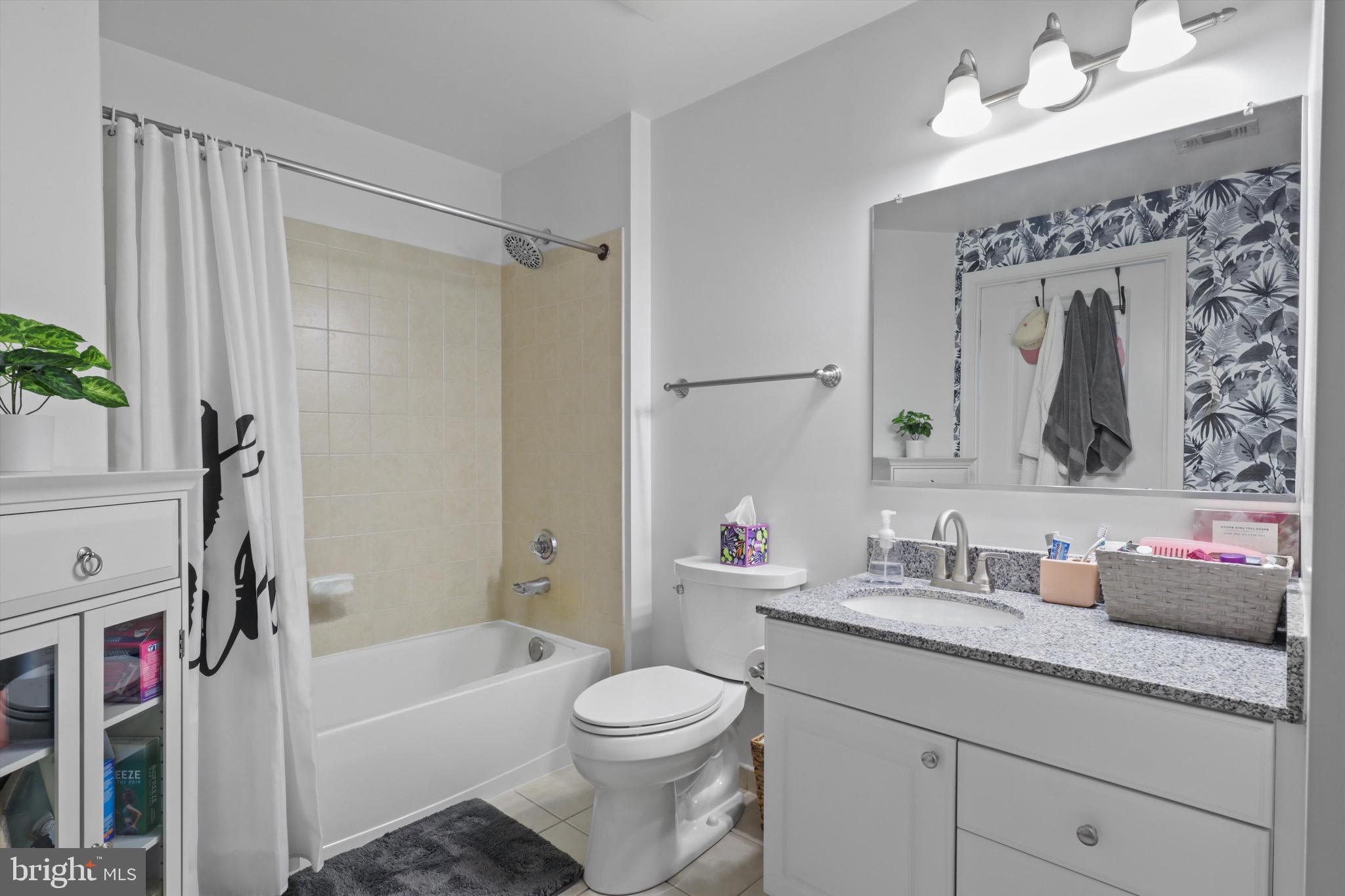 3600 South Glebe Road, Unit 414W Arlington, VA 22202 - Photo 19 of 60 a bathroom with a granite countertop sink mirror vanity and toilet