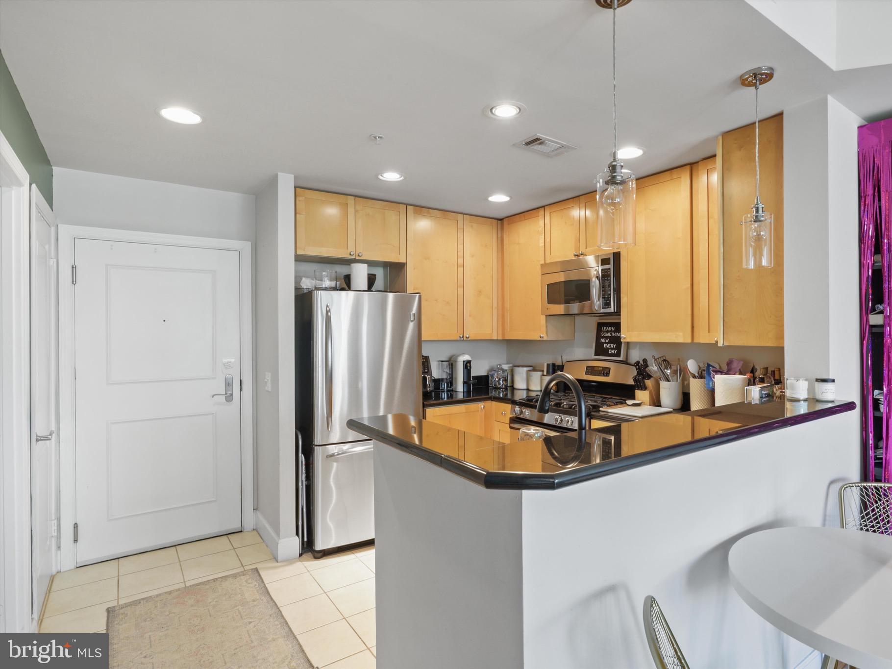 3600 South Glebe Road, Unit 414W Arlington, VA 22202 - Photo 3 of 60 a kitchen with sink refrigerator and cabinets