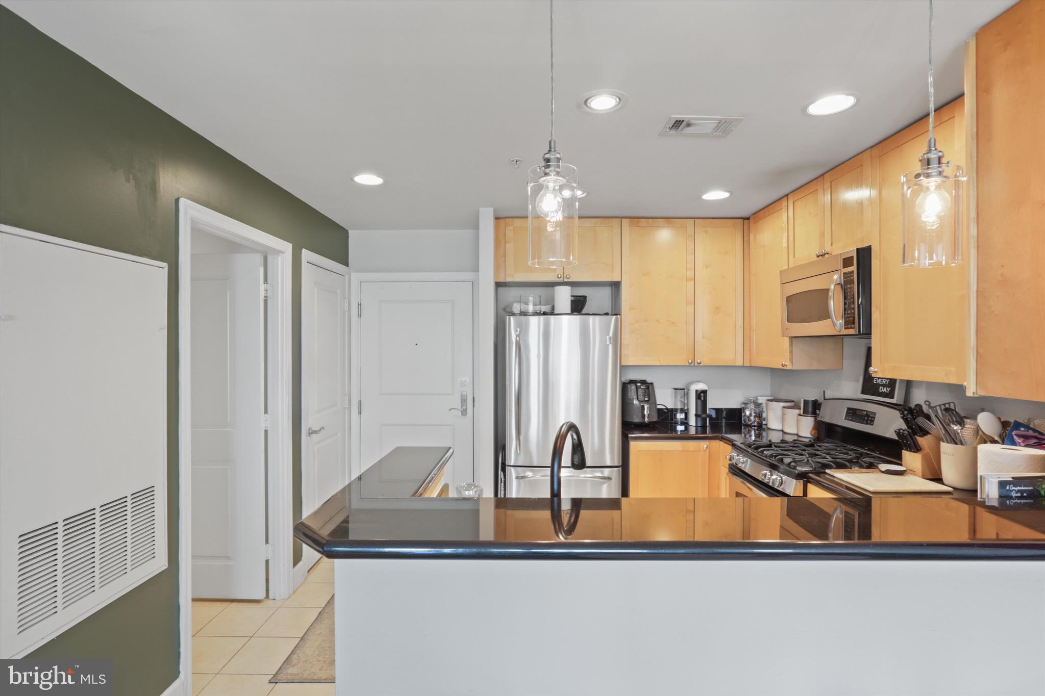 3600 South Glebe Road, Unit 414W Arlington, VA 22202 - Photo 4 of 60 a kitchen with stainless steel appliances granite countertop a sink refrigerator and cabinets