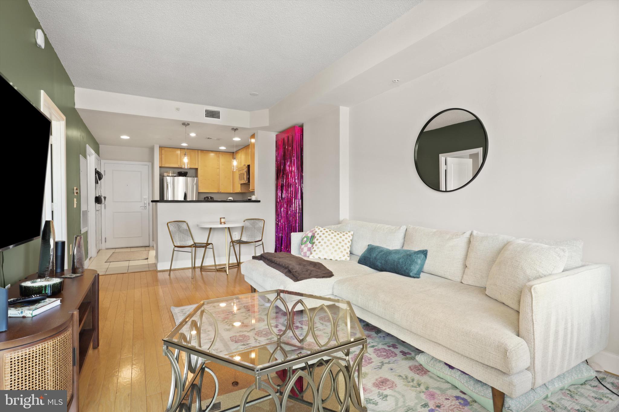 3600 South Glebe Road, Unit 414W Arlington, VA 22202 - Photo 10 of 60 a living room with furniture a flat screen tv and kitchen view