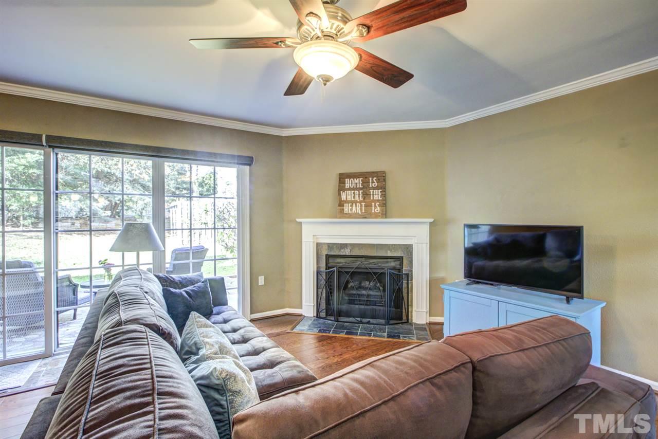 7625 Falcon Rest Circle, Unit 7625 Raleigh, NC 27615 - Photo 12 of 29 a living room with furniture a flat screen tv and a fireplace
