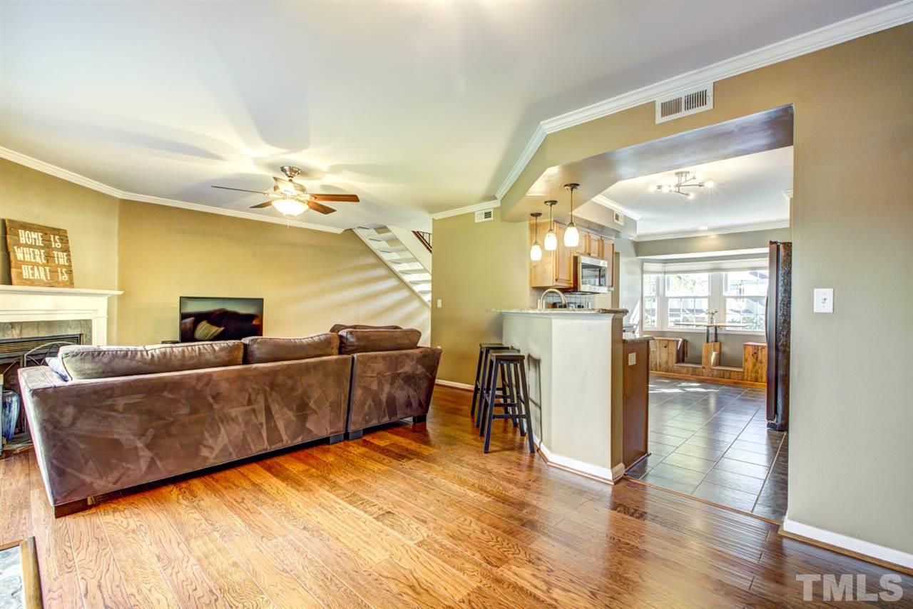 7625 Falcon Rest Circle, Unit 7625 Raleigh, NC 27615 - Photo 13 of 29 a living room with furniture and a chandelier