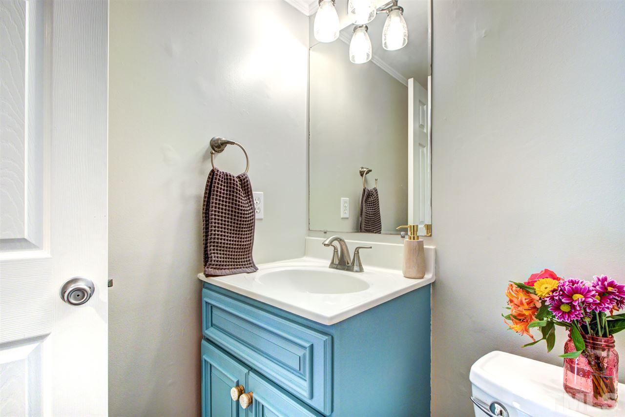 7625 Falcon Rest Circle, Unit 7625 Raleigh, NC 27615 - Photo 14 of 29 a bathroom with a sink vanity and a mirror