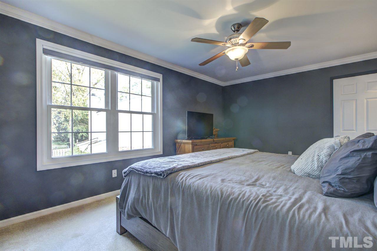 7625 Falcon Rest Circle, Unit 7625 Raleigh, NC 27615 - Photo 17 of 29 a bedroom with a large bed and a large window
