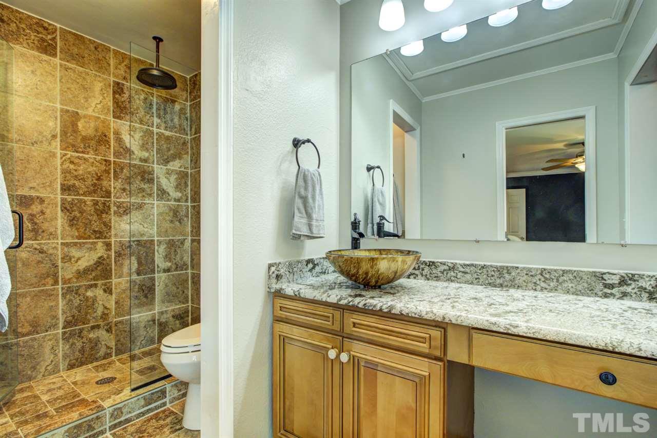 7625 Falcon Rest Circle, Unit 7625 Raleigh, NC 27615 - Photo 18 of 29 a bathroom with a granite countertop sink and a mirror
