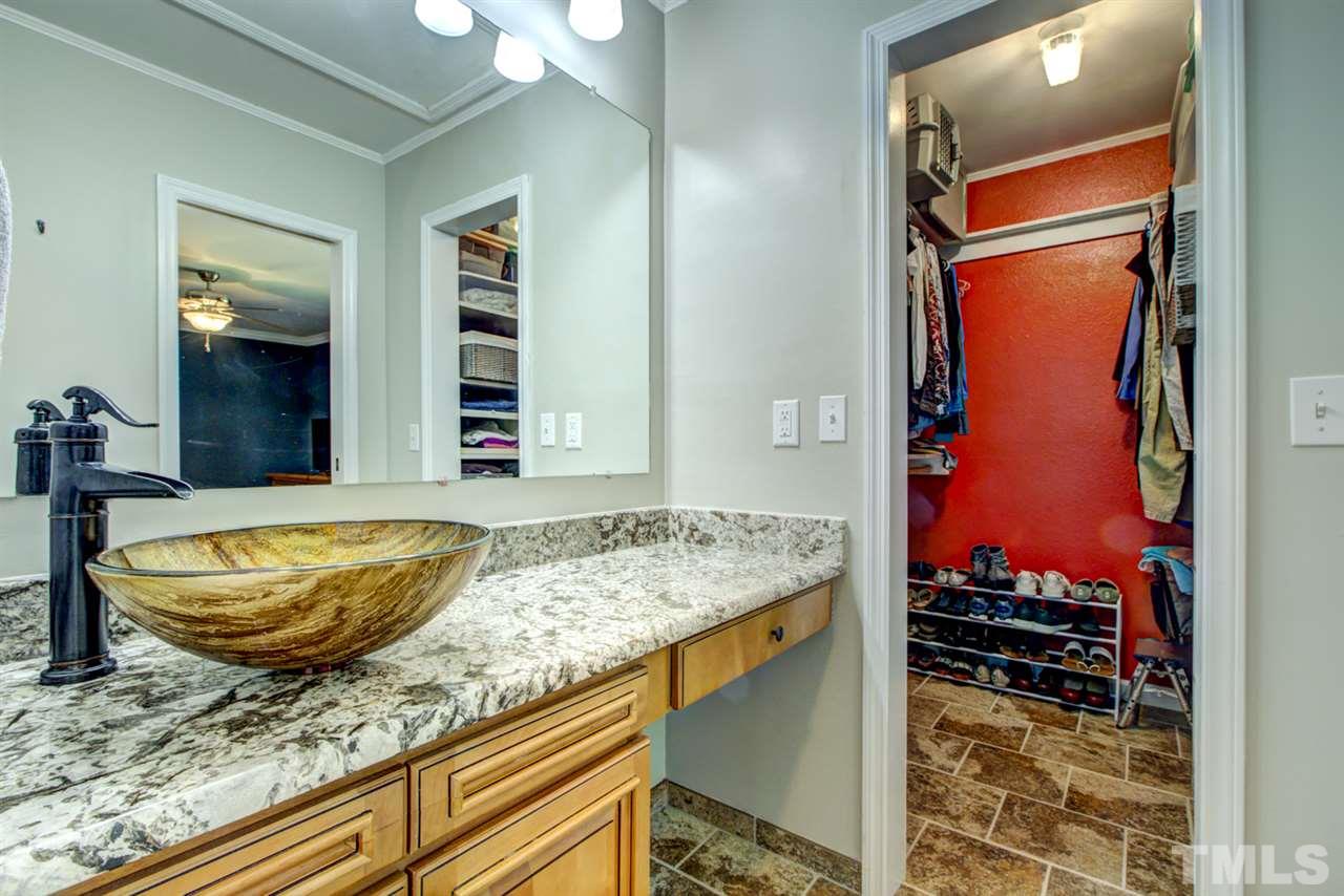 7625 Falcon Rest Circle, Unit 7625 Raleigh, NC 27615 - Photo 19 of 29 a bathroom with a granite countertop sink and a mirror