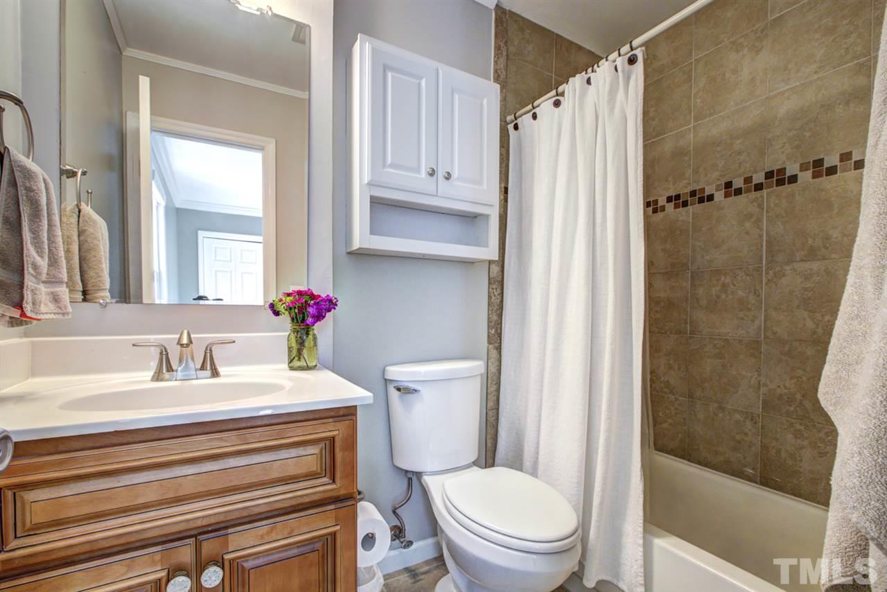 7625 Falcon Rest Circle, Unit 7625 Raleigh, NC 27615 - Photo 22 of 29 a bathroom with a sink a toilet and shower