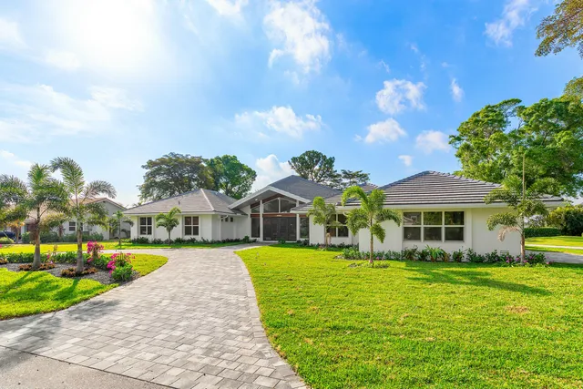 a front view of house with yard and green space
