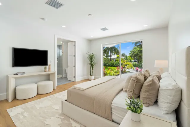a bedroom with a bed and a flat screen tv