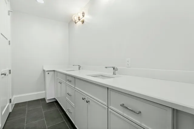 a bathroom with a granite countertop sink a toilet and shower