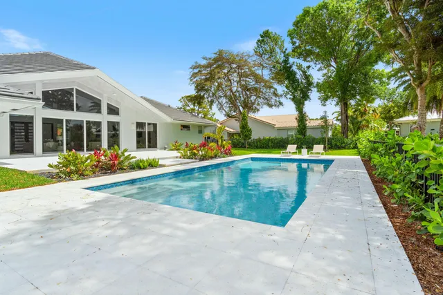 a view of a backyard with swimming pool
