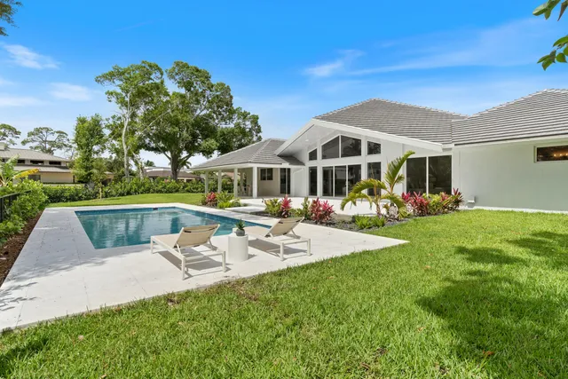 a view of a house with a big yard and potted plants