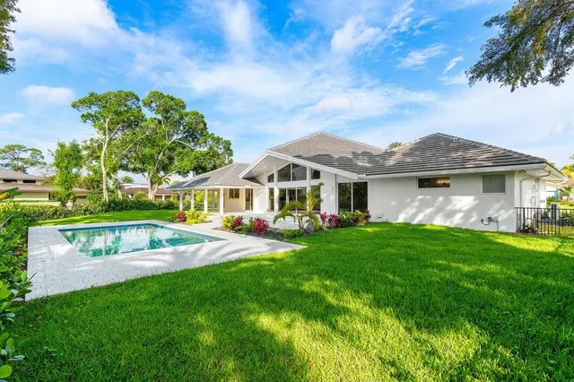 an aerial view of residential house with outdoor space and swimming pool