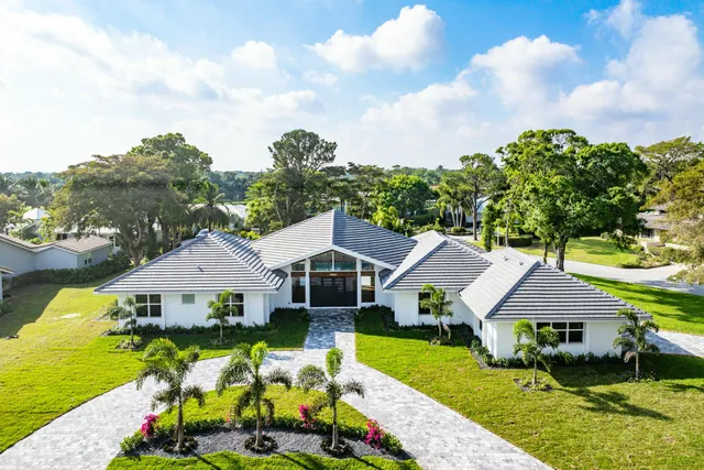 an aerial view of residential houses with outdoor space and swimming pool