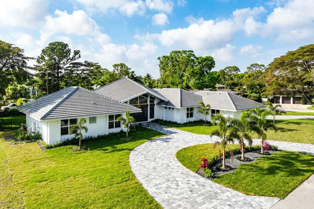 an aerial view of residential houses with outdoor space and swimming pool