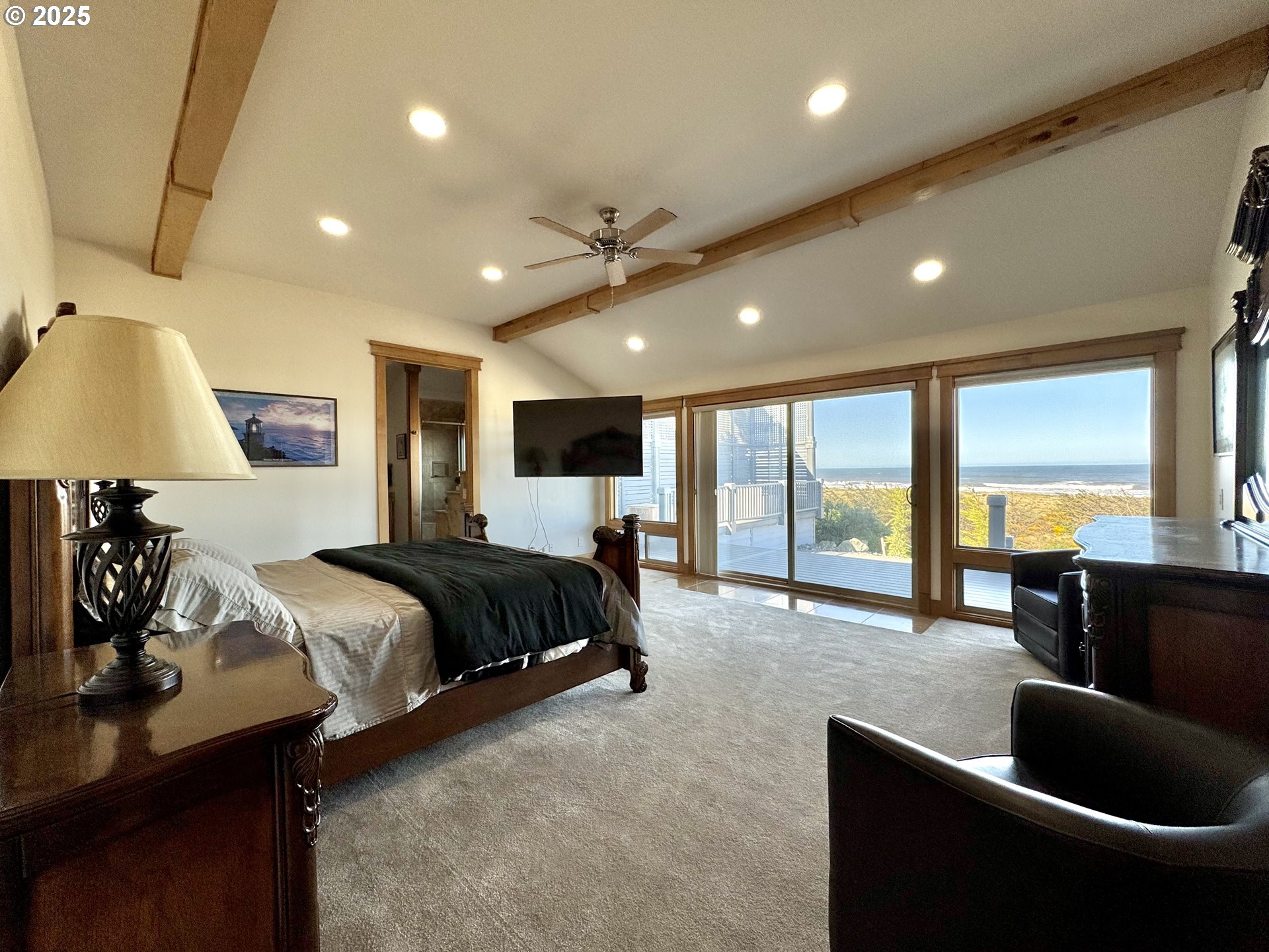 94098 Rubys Way Gold Beach, OR 97444 - Photo 15 of 48 a spacious bedroom with a large bed and a large window