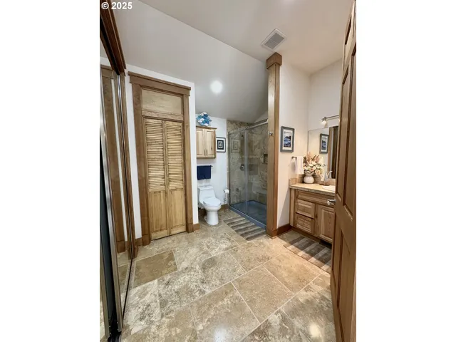 a bathroom with a granite countertop shower a sink and a mirror