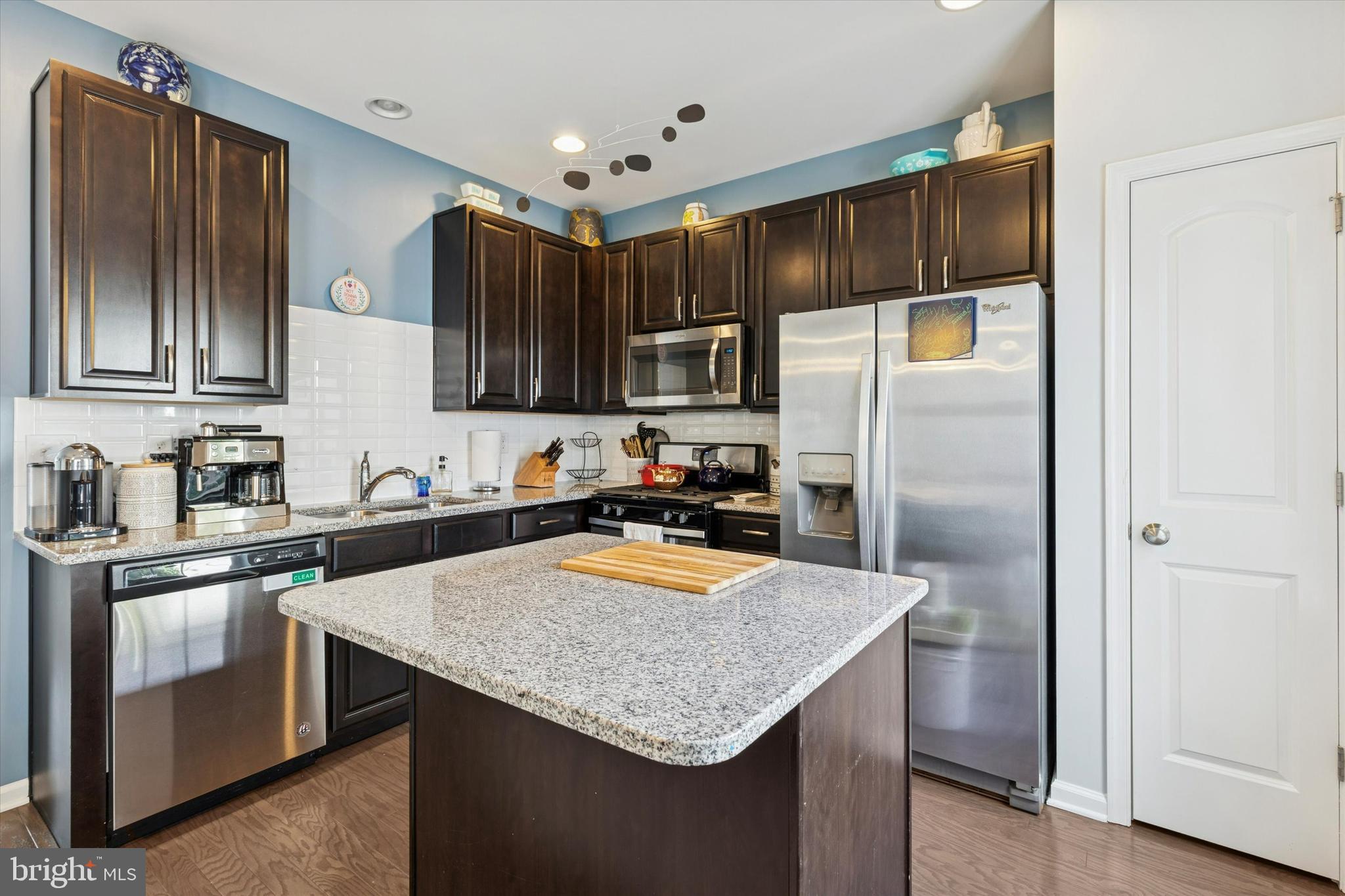 3711 Jacob Stout Road, Unit 5 Doylestown, PA 18902 - Photo 12 of 25 a kitchen with granite countertop stainless steel appliances a refrigerator sink and microwave