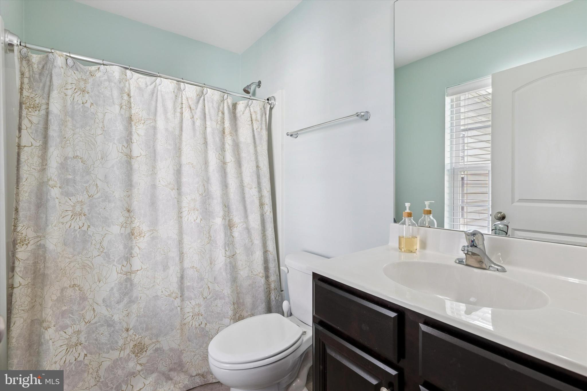 3711 Jacob Stout Road, Unit 5 Doylestown, PA 18902 - Photo 22 of 25 a bathroom with a sink a toilet and shower curtain