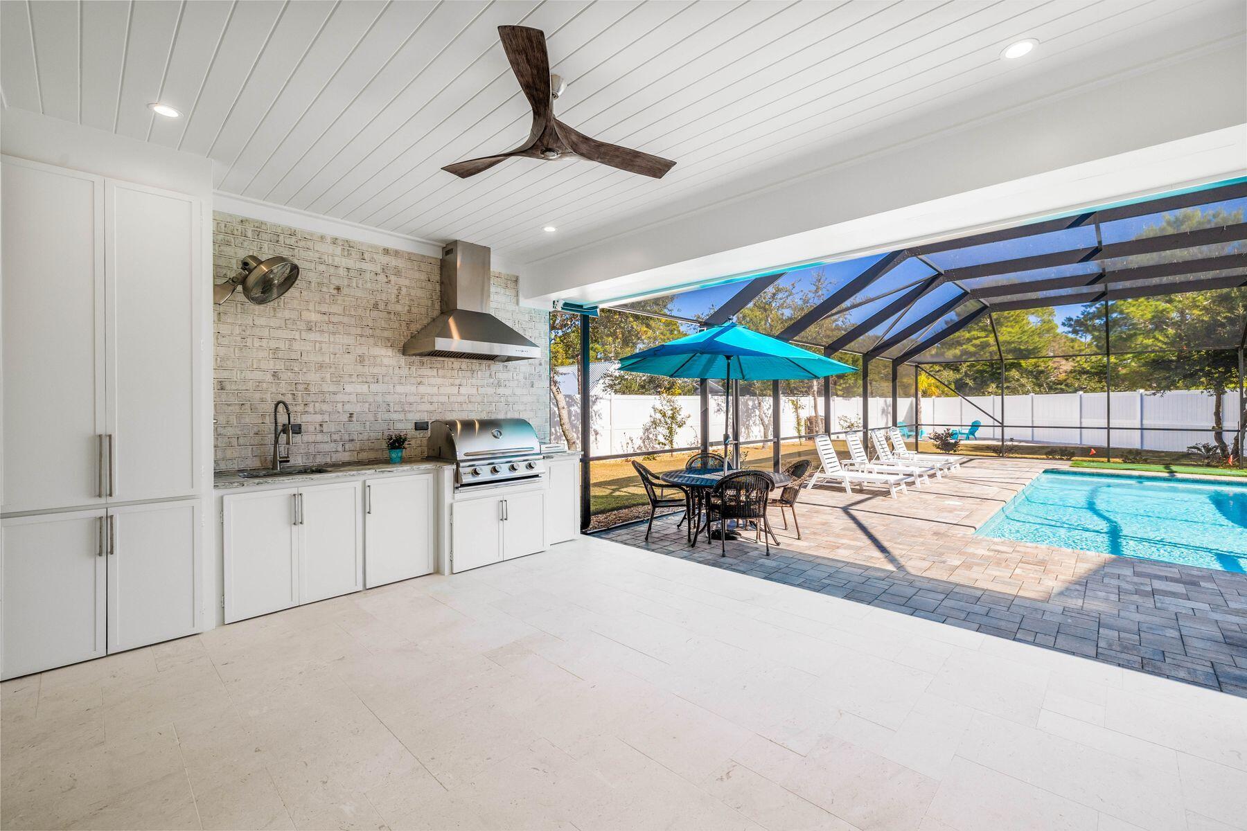 274 Ridge Road Santa Rosa Beach, FL 32459 - Photo 14 of 40 a kitchen with stainless steel appliances granite countertop a stove and a view of living room