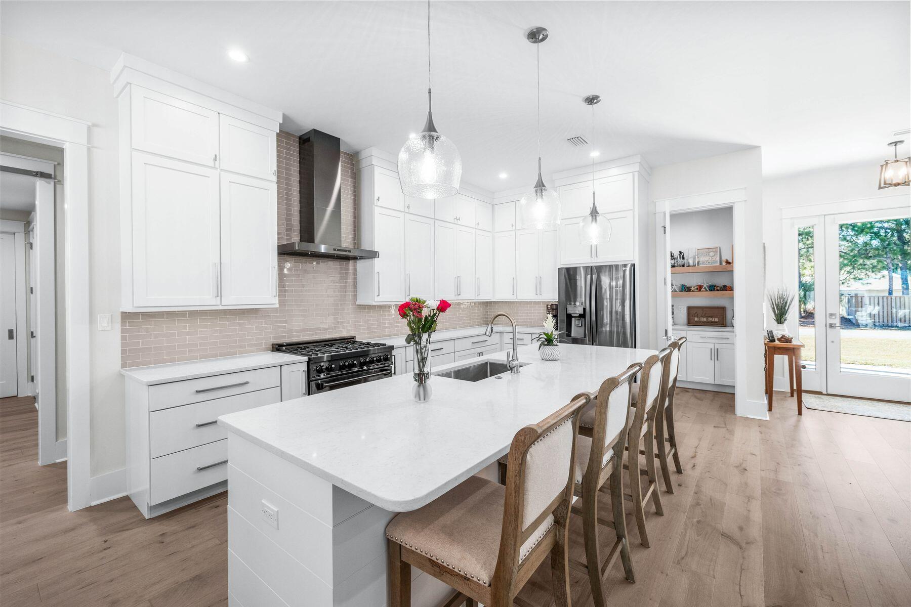274 Ridge Road Santa Rosa Beach, FL 32459 - Photo 8 of 40 a kitchen with a dining table chairs stainless steel appliances and cabinets