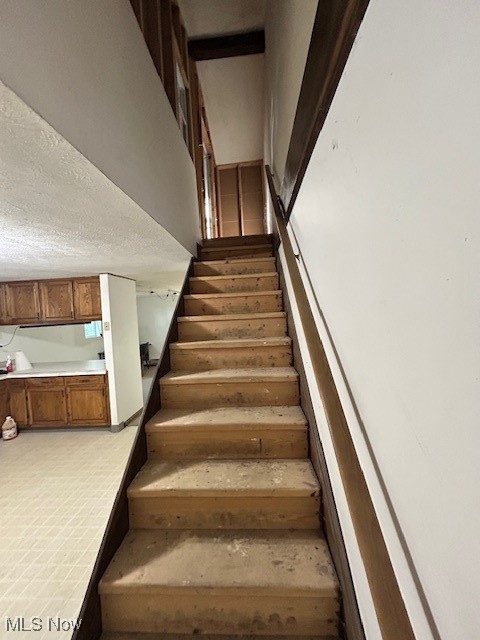 17510 Munn Road Chagrin Falls, OH 44023 - Photo 32 of 35 Stairway featuring a textured ceiling