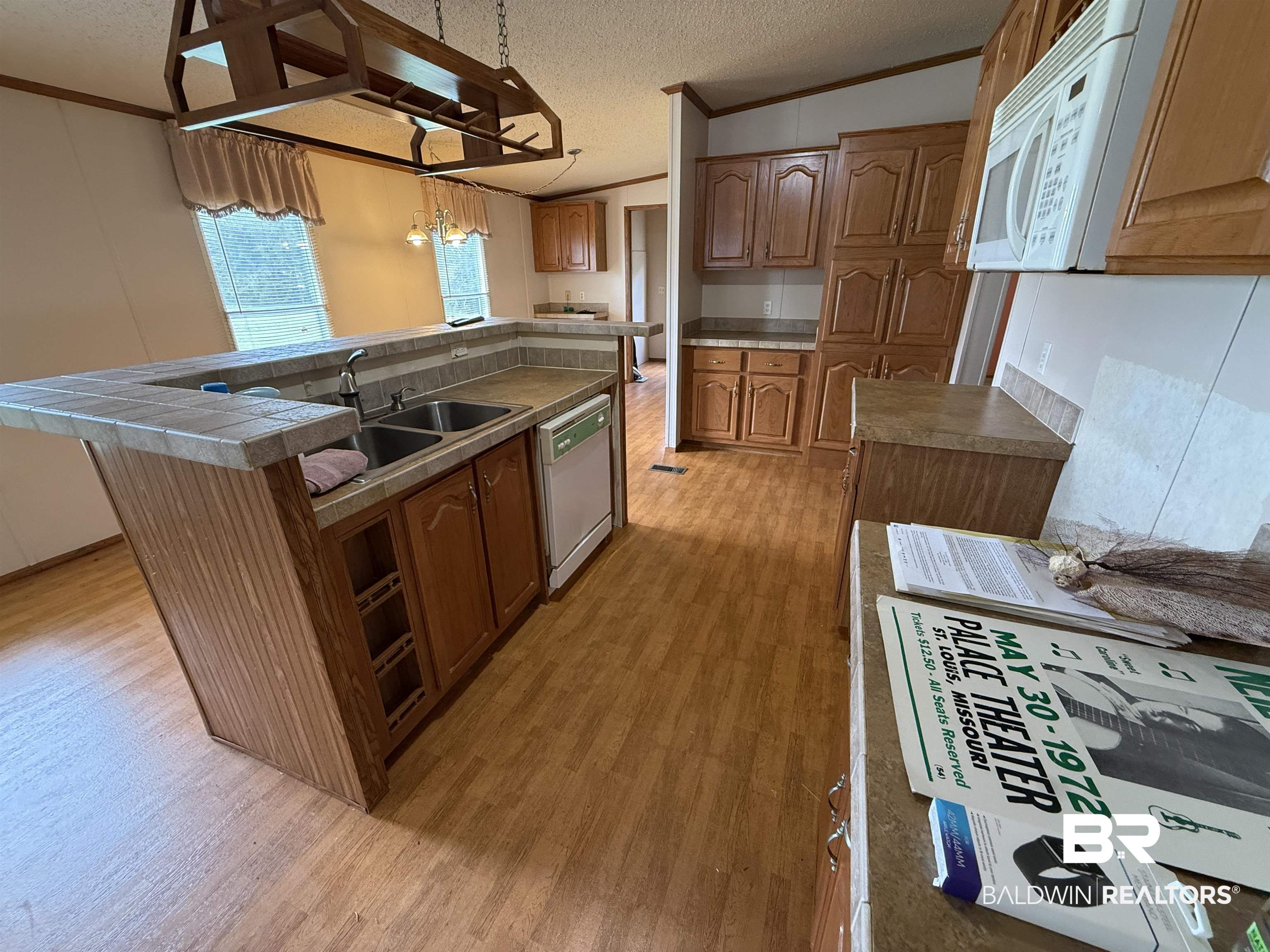 14402 County Road 55 Foley, AL 36535 - Photo 8 of 20 Kitchen featuring light hardwood / wood-style flooring, a center island, pendant lighting, a textured ceiling, and white appliances