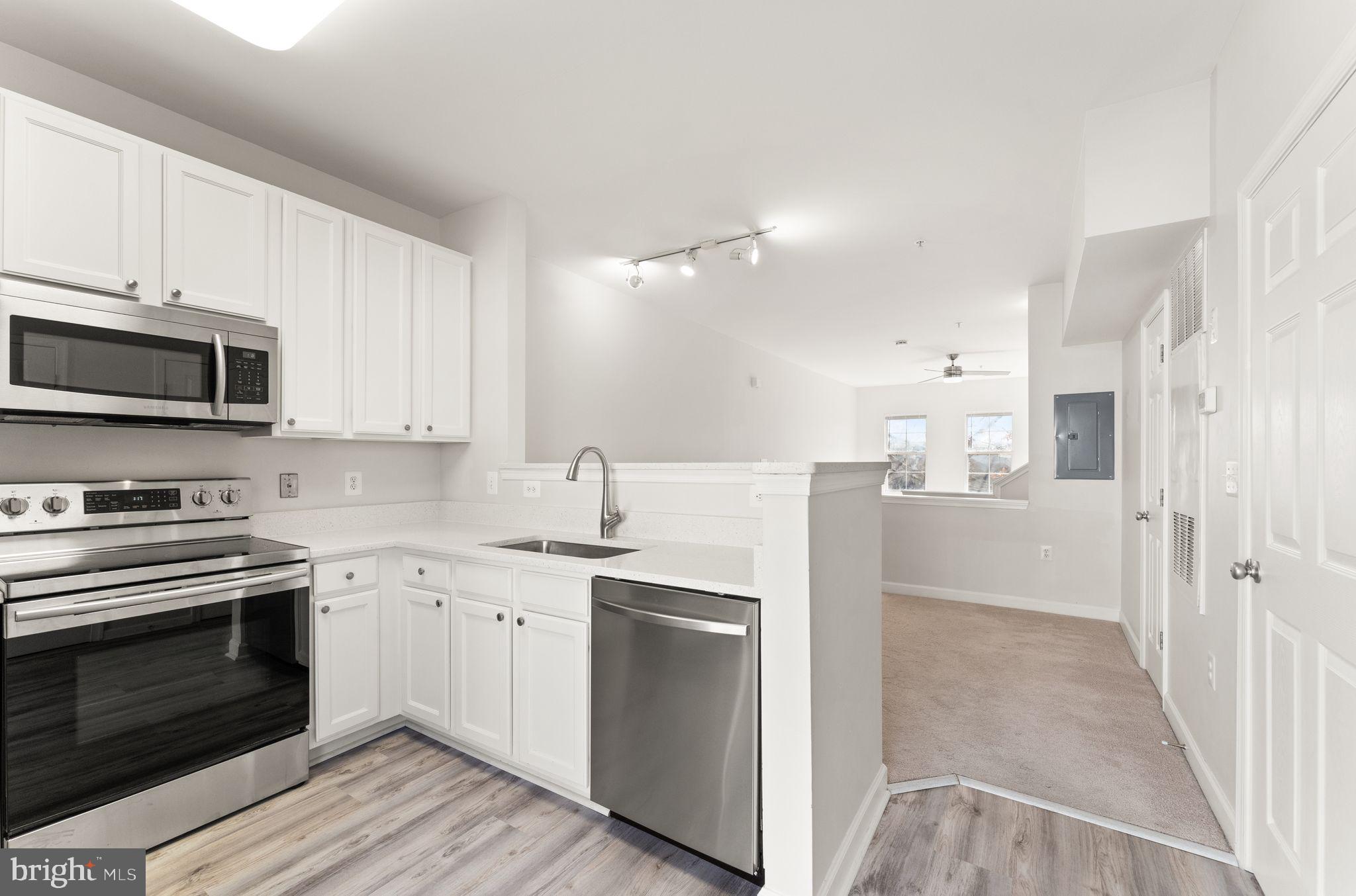 42427 Goldenseal Square Brambleton, VA 20148 - Photo 13 of 52 a kitchen with a sink a stove and refrigerator
