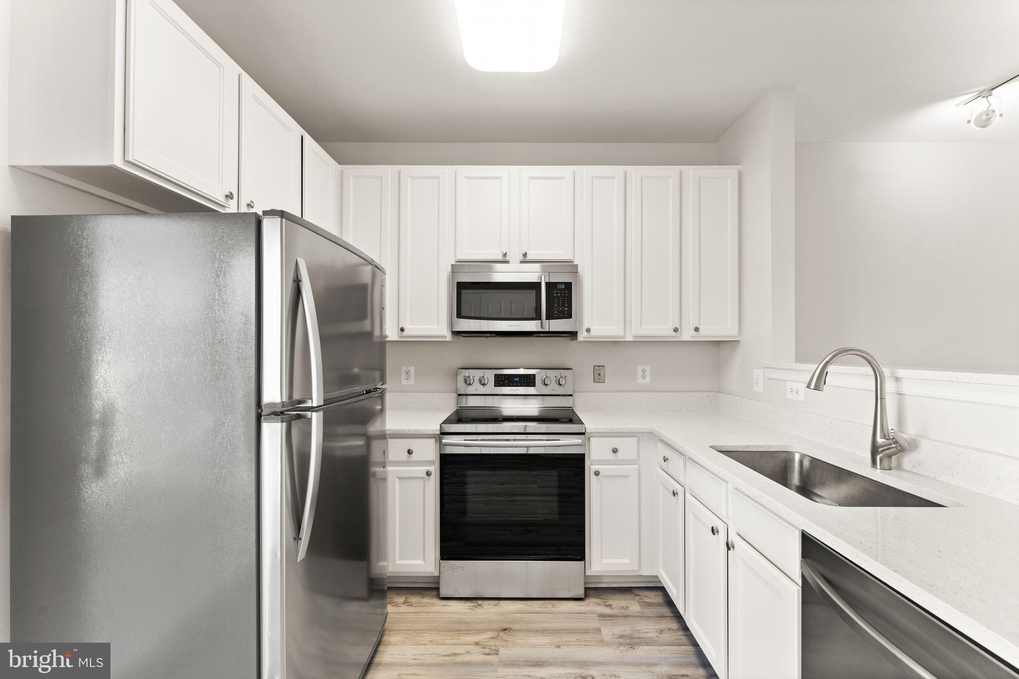 42427 Goldenseal Square Brambleton, VA 20148 - Photo 14 of 52 a kitchen with a sink stove and refrigerator
