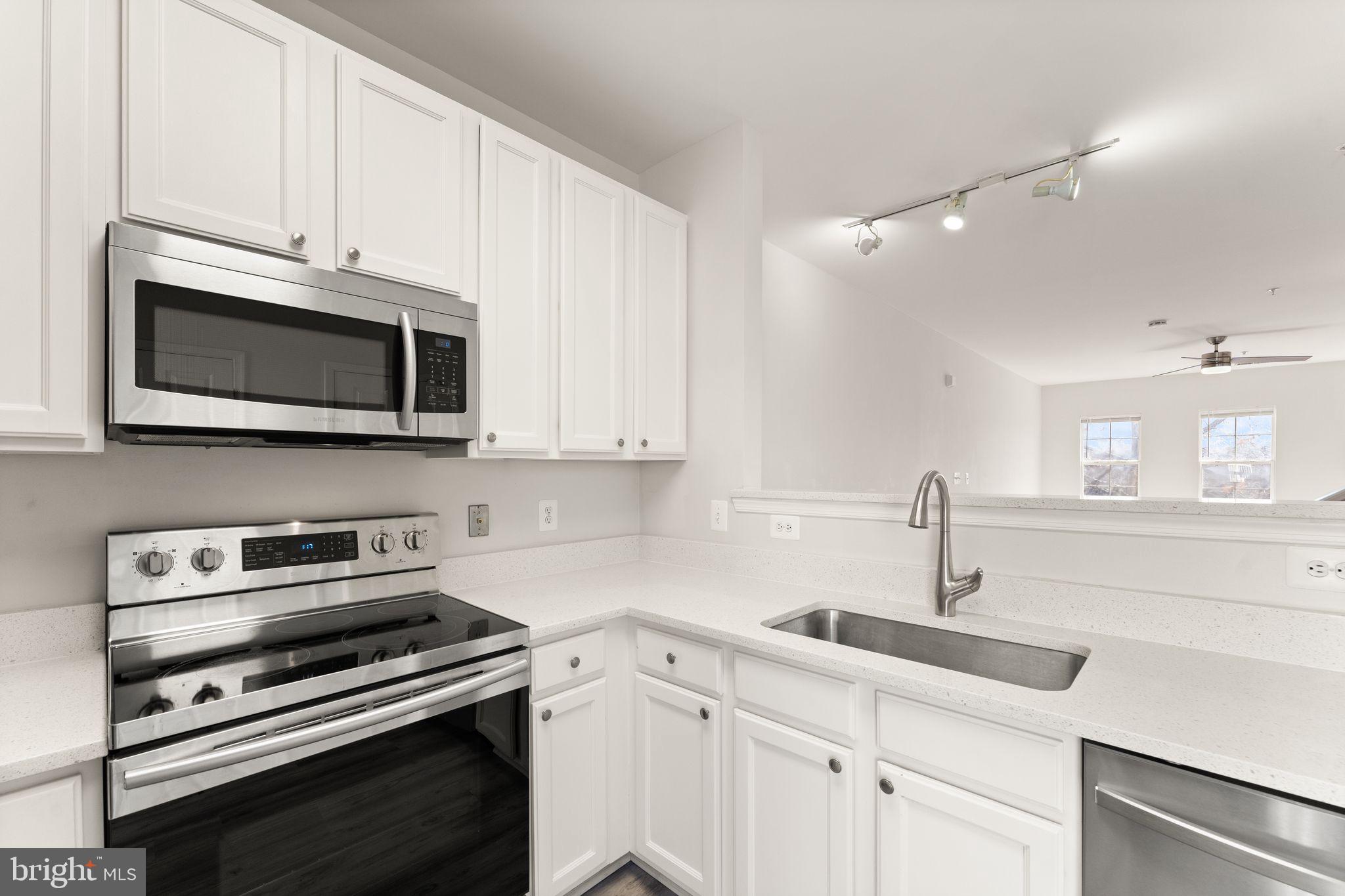 42427 Goldenseal Square Brambleton, VA 20148 - Photo 15 of 52 a kitchen with cabinets stainless steel appliances and a sink