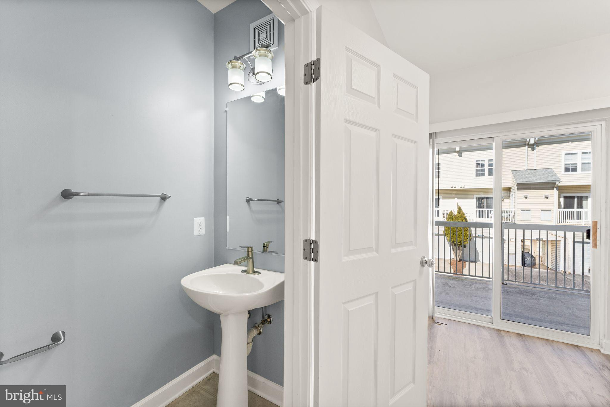 42427 Goldenseal Square Brambleton, VA 20148 - Photo 18 of 52 a bathroom with a sink a mirror and a shower