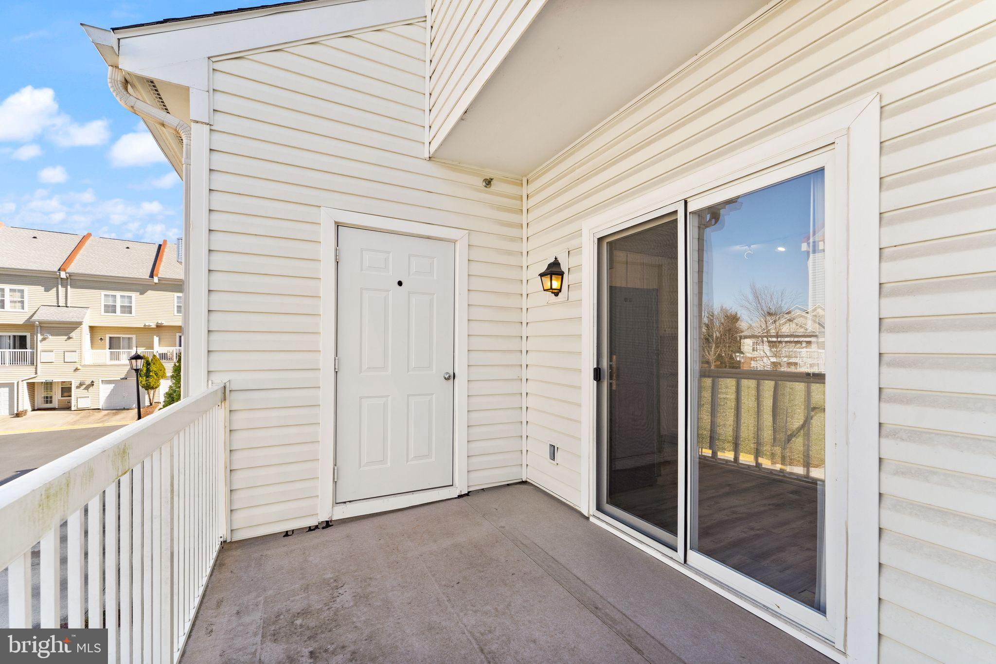 42427 Goldenseal Square Brambleton, VA 20148 - Photo 21 of 52 a view of a porch with a door and wooden floor