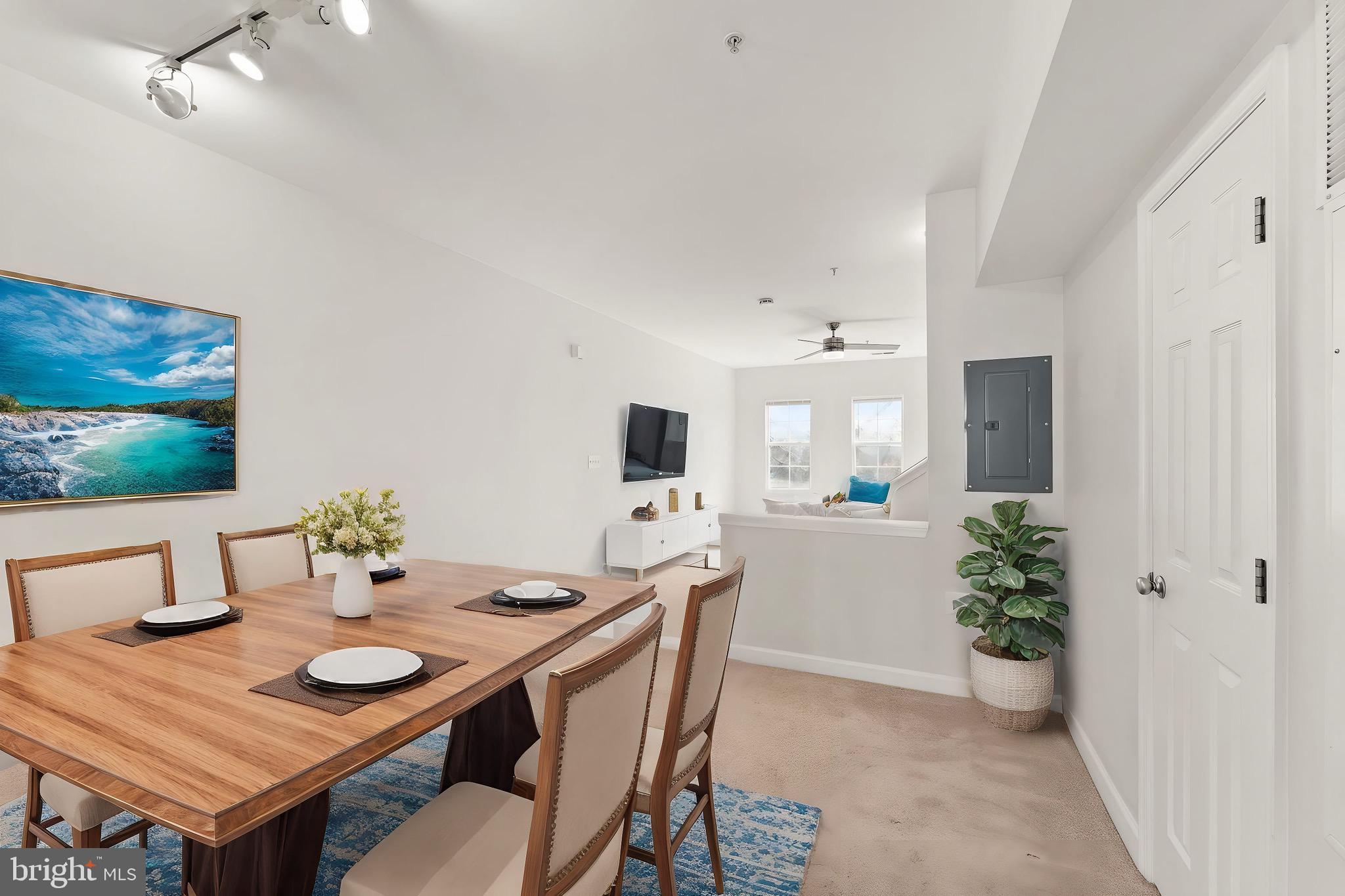 42427 Goldenseal Square Brambleton, VA 20148 - Photo 24 of 52 a view of a dining room with furniture and wooden floor