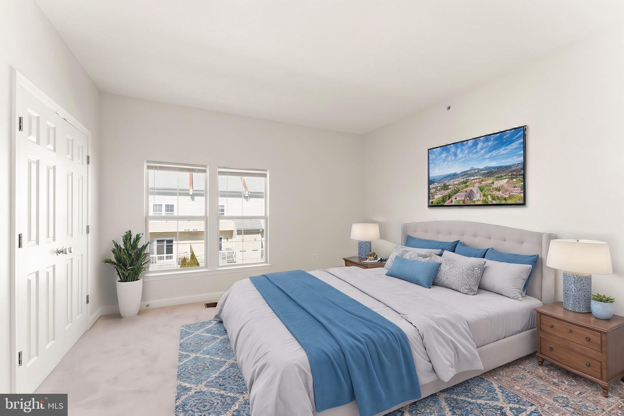 42427 Goldenseal Square Brambleton, VA 20148 - Photo 38 of 52 a bedroom with a large bed and a large window