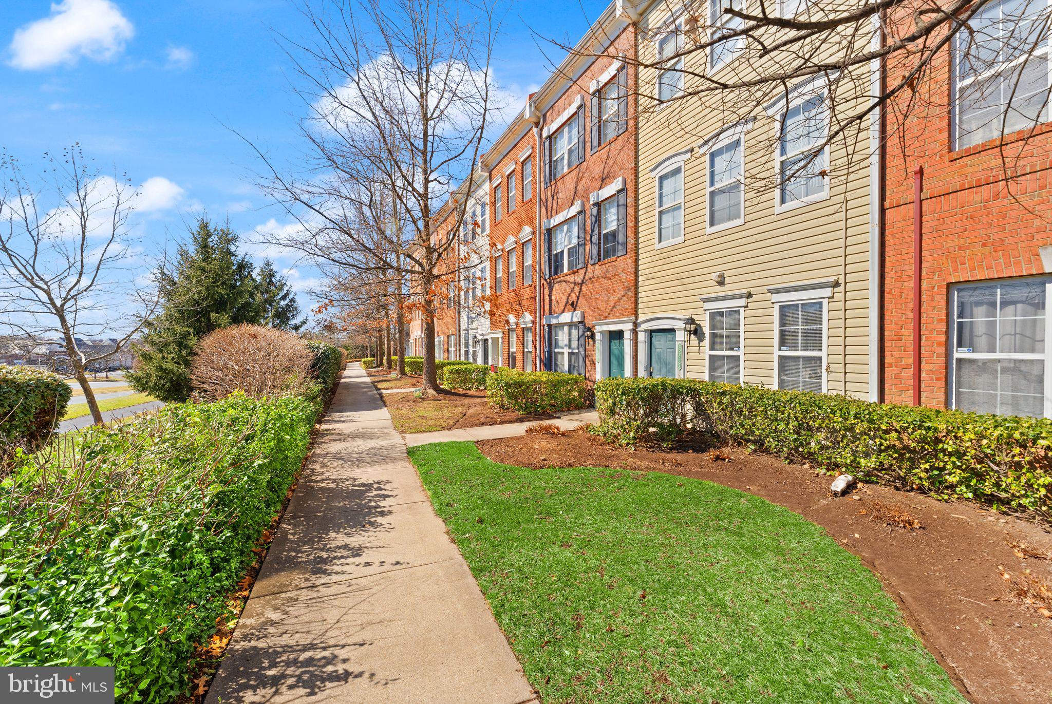 42427 Goldenseal Square Brambleton, VA 20148 - Photo 4 of 52 a front view of a building with garden