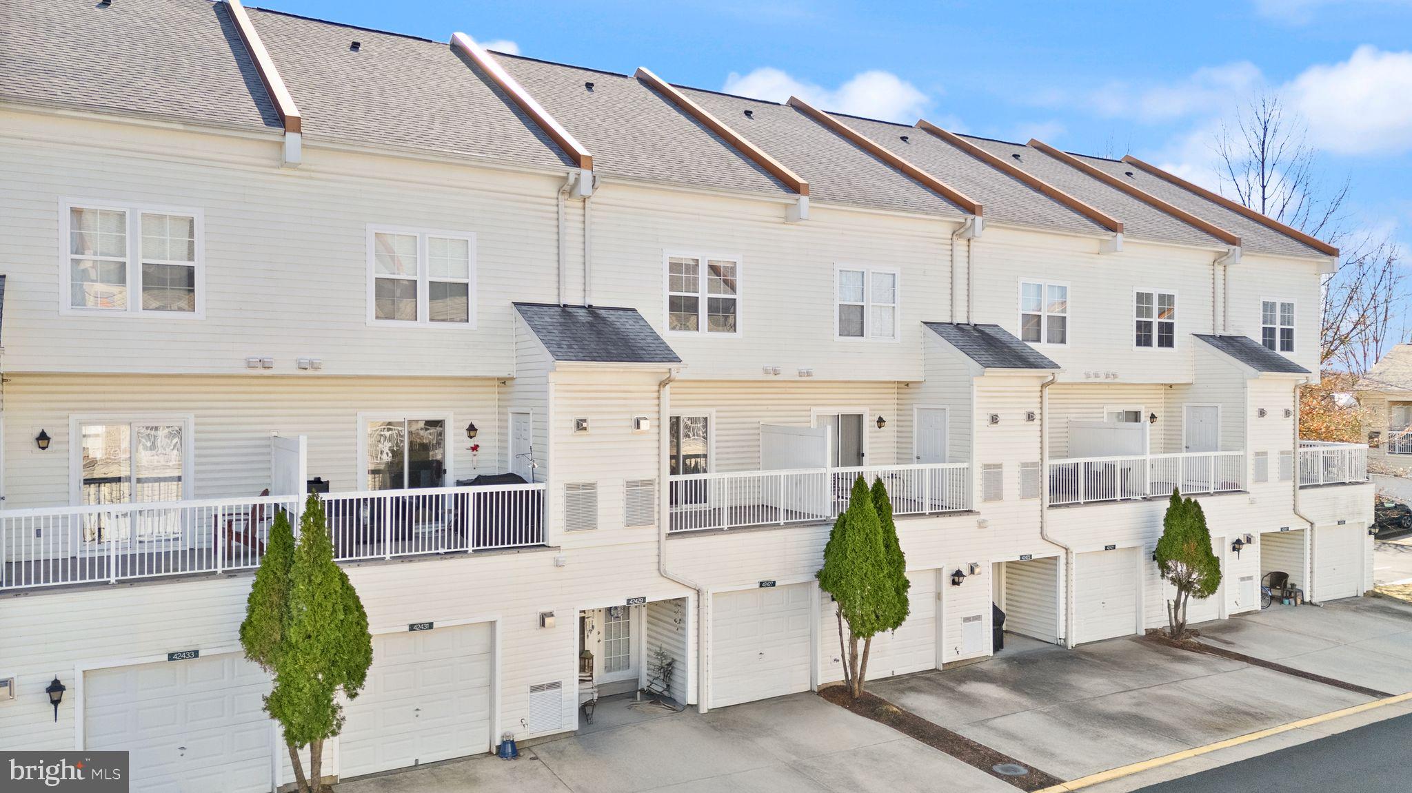 42427 Goldenseal Square Brambleton, VA 20148 - Photo 48 of 52 a view of a white building with many windows