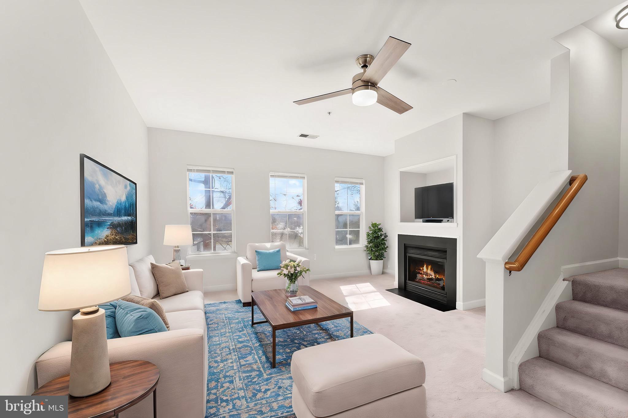 42427 Goldenseal Square Brambleton, VA 20148 - Photo 9 of 52 a living room with furniture flat screen tv and a fireplace