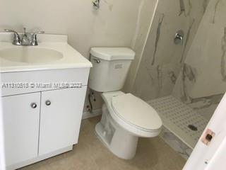 Westchester Miami, FL 33155 - Photo 5 of 8 a white toilet sitting next to a bathroom sink