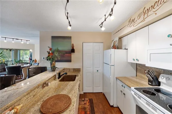 a kitchen with a sink a refrigerator and a stove
