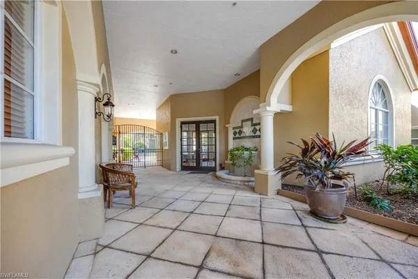 a lobby with furniture and potted plants