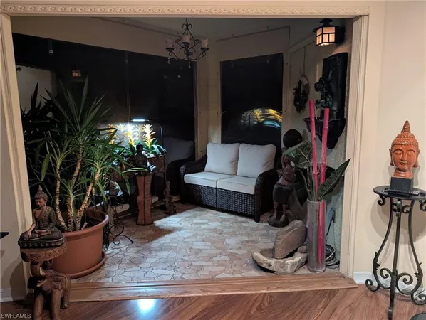 a living room filled with furniture and a potted plant