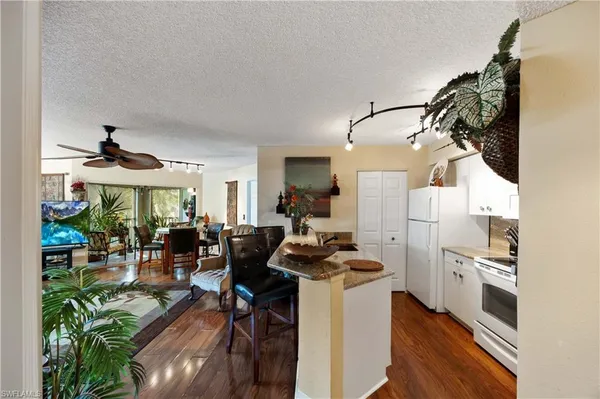 a view of a dining room with furniture wooden floor and a chandelier