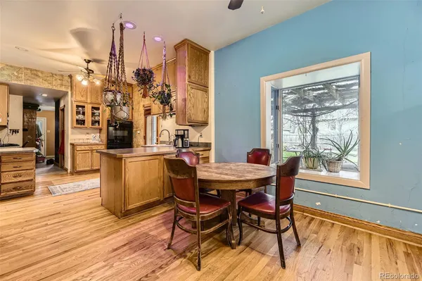 a dining room with furniture and wooden floor