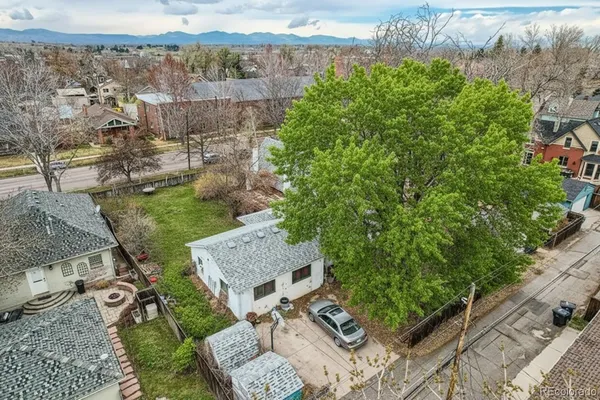 an aerial view of a house with a yard and lake view