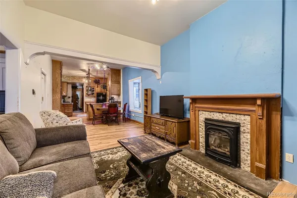 a living room with furniture a flat screen tv and a fireplace