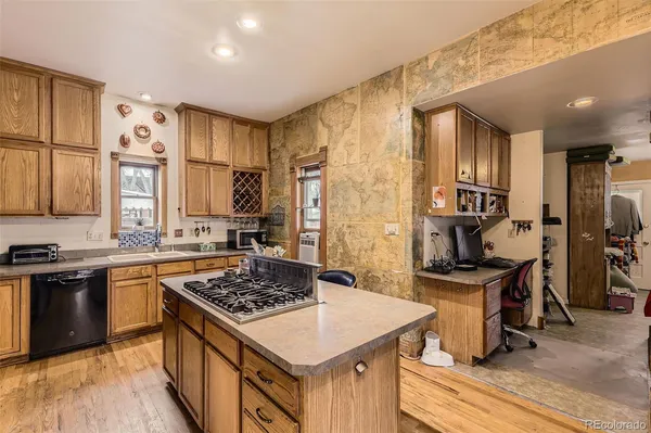 a kitchen with a stove a sink dishwasher and a refrigerator